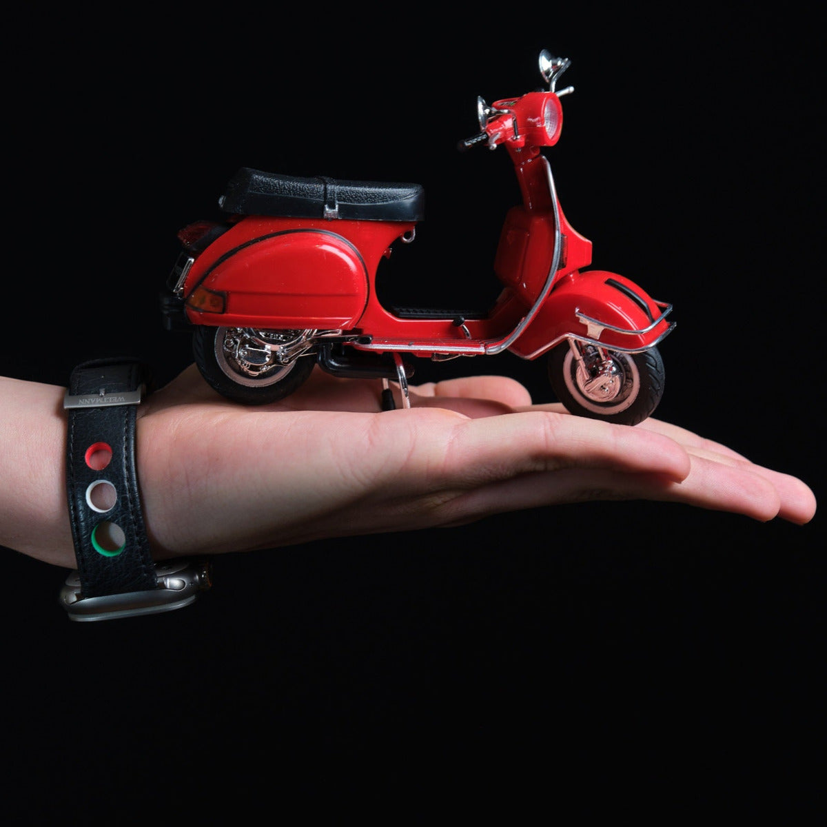 Vespa on hand Italian colors